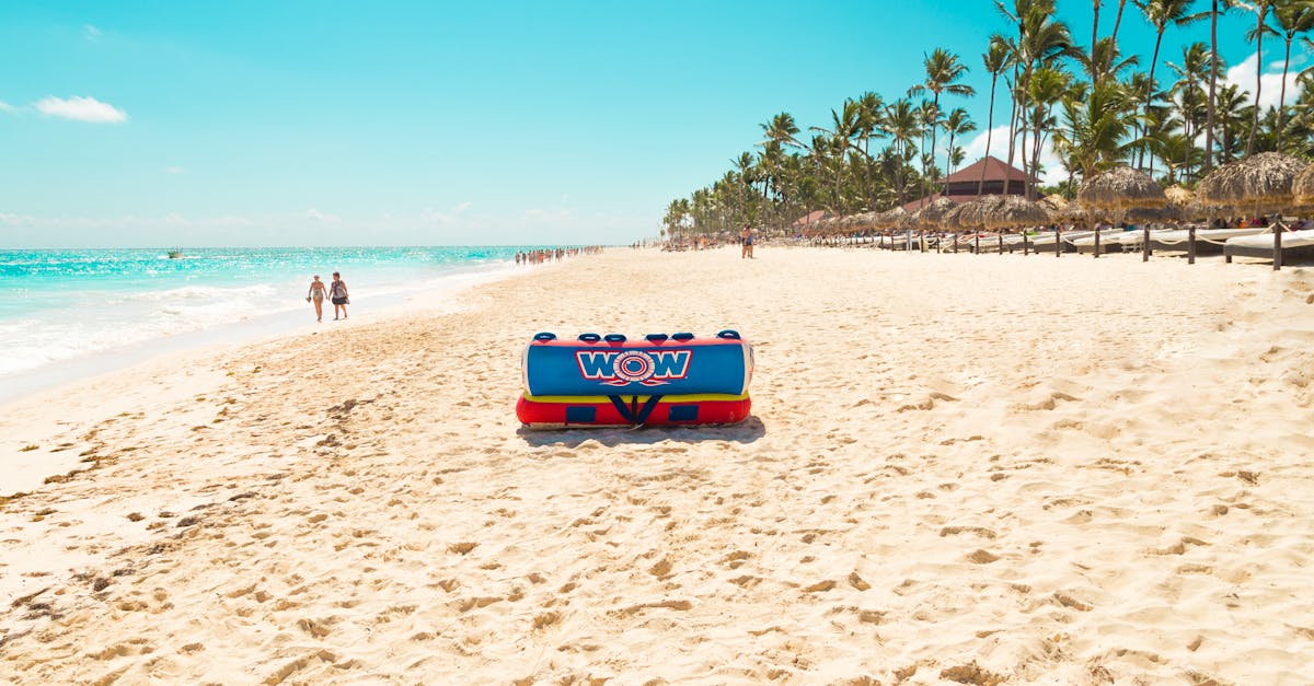 Relaxing scene on Punta Cana beach with inflatable raft and clear skies.